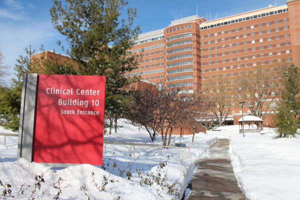 Snow covered landscape of healthcare center with cleared sidewalk